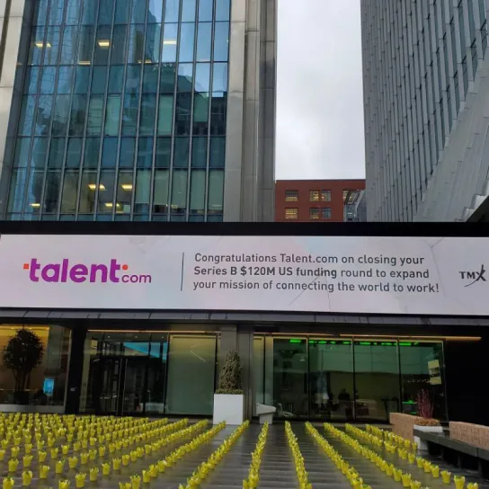 A billboard promoting Talent.com is prominently displayed in front of a building, showcasing job opportunities.